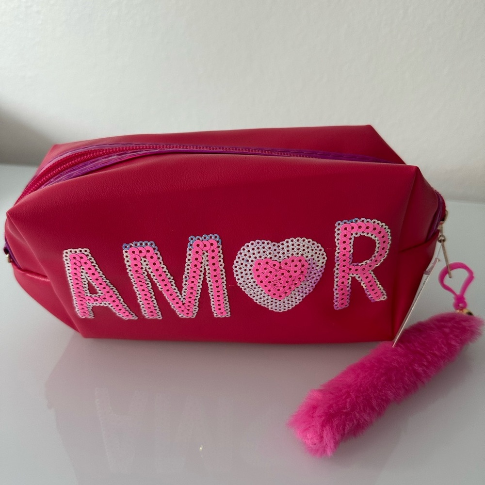 Pink makeup bag with the word “LOVE” in sequins and a pink tail.NWT